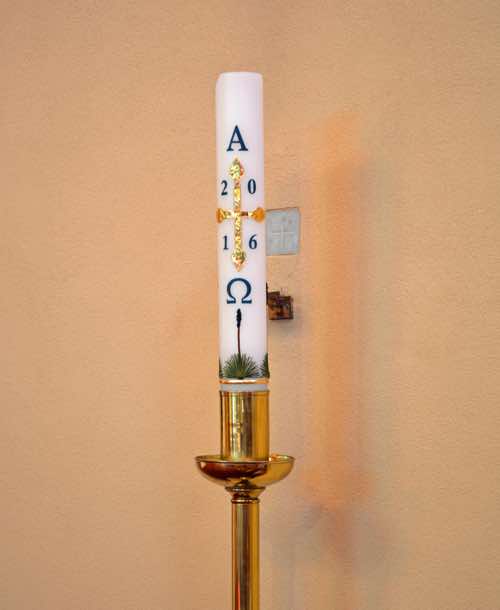 The Paschal candle stands nearby.  It has special significance at Easter where it represents the risen Christ, as a symbol of light (life) dispelling darkness (death).