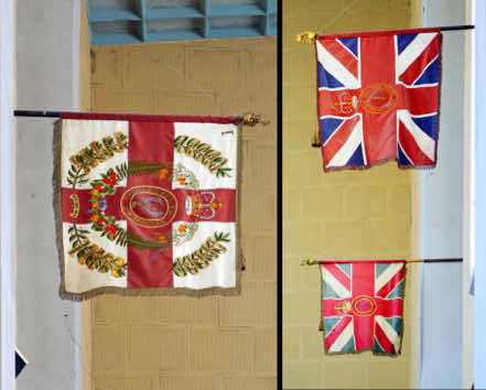 The flags hanging from the walls of the back gallery are the colours of the Hawke’s Bay Regiment.  The newer pair were presented to the Regiment by the Queen in Napier in 1963.