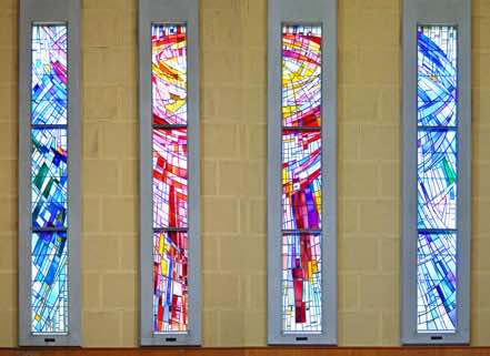These windows were designed by Beverley Shore-Bennett of Wellington, and created by Miller Studios of Dunedin.  They are an abstract design, and are at their spectacular best in the evening when the sun is low.  [8]  [Click to ZOOM.]