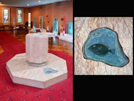 The font is made of Italian marble and NZ granite with a carved greenstone John Dory fish.  In it is embedded the remains of the first font, a gift from the English diocese of St Edmondsbury and Ipswich.  [5]