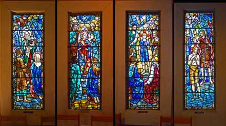 The Baptistry Chapel windows were made by Whitefriar Studios, England.  They depict the childhood and baptism of Jesus: the blessing of Simeon; adoration of the Magi; Jesus teaching in the Temple; the baptism of Jesus.  [6]  [Click to ZOOM.]