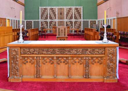 Like the pulpit, the altar is in traditional English style, though the work of New Zealand craftsmen.  The altar was designed by W. Andrews of Tauranga, and following his death, completed by C. E. Cross in 1946.  It is a memorial to parishioners who served in World War II.  [16]