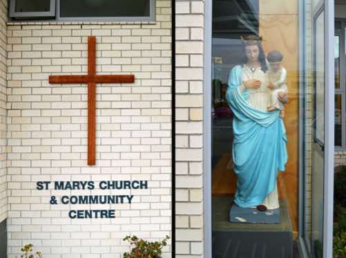 Here there is a Church sign, and a statue of Madonna and Child.  The colour blue is often associated with Mary, signfying purity.