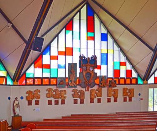 At bottom left is a statue of Joseph and Jesus, and across the base of the window are a number of Māori carvings.  But what do they mean?