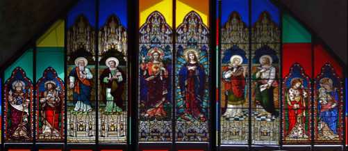 Again these are very fine stained glass windows.  The figures depitced are (from left):  • St Patrick  •St Joseph  • St Luke  • St Matthew  • The Sacred Heart  • Mary  • St John  • St Mark  • St Clare  • Mary and Child.   [Click photo to ZOOM IN]